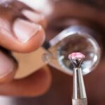 Thecut of a diamond being examined under a loupe